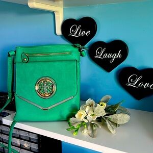 Beautiful bright green crossover bag with gold detail.